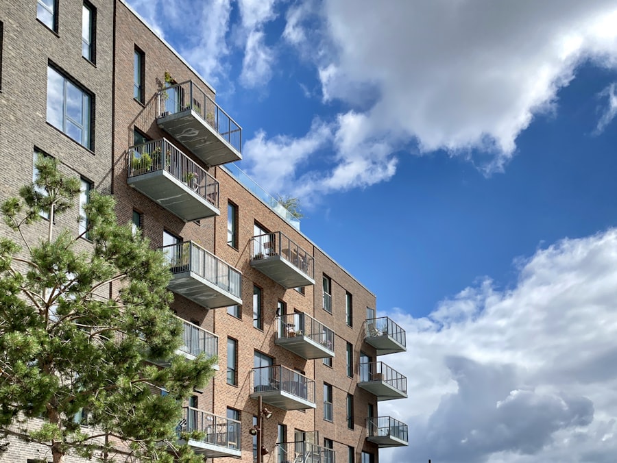 A brick co-op apartment building with balconies against a blue sky