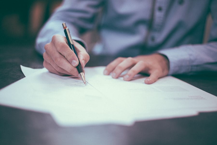 A person signing a contract with a pen