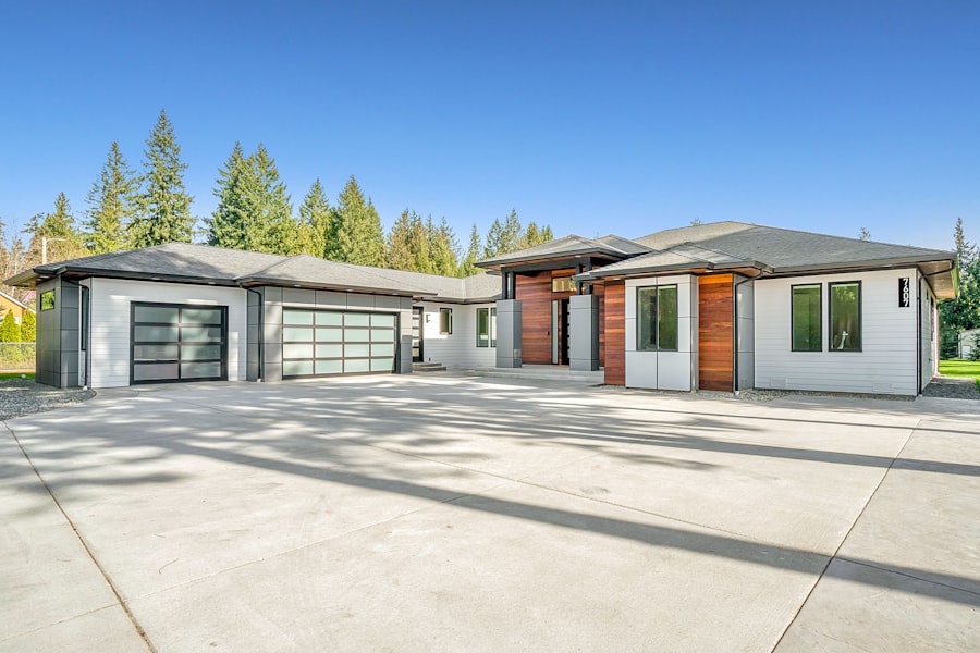 A modern single level ranch home with a wide driveway