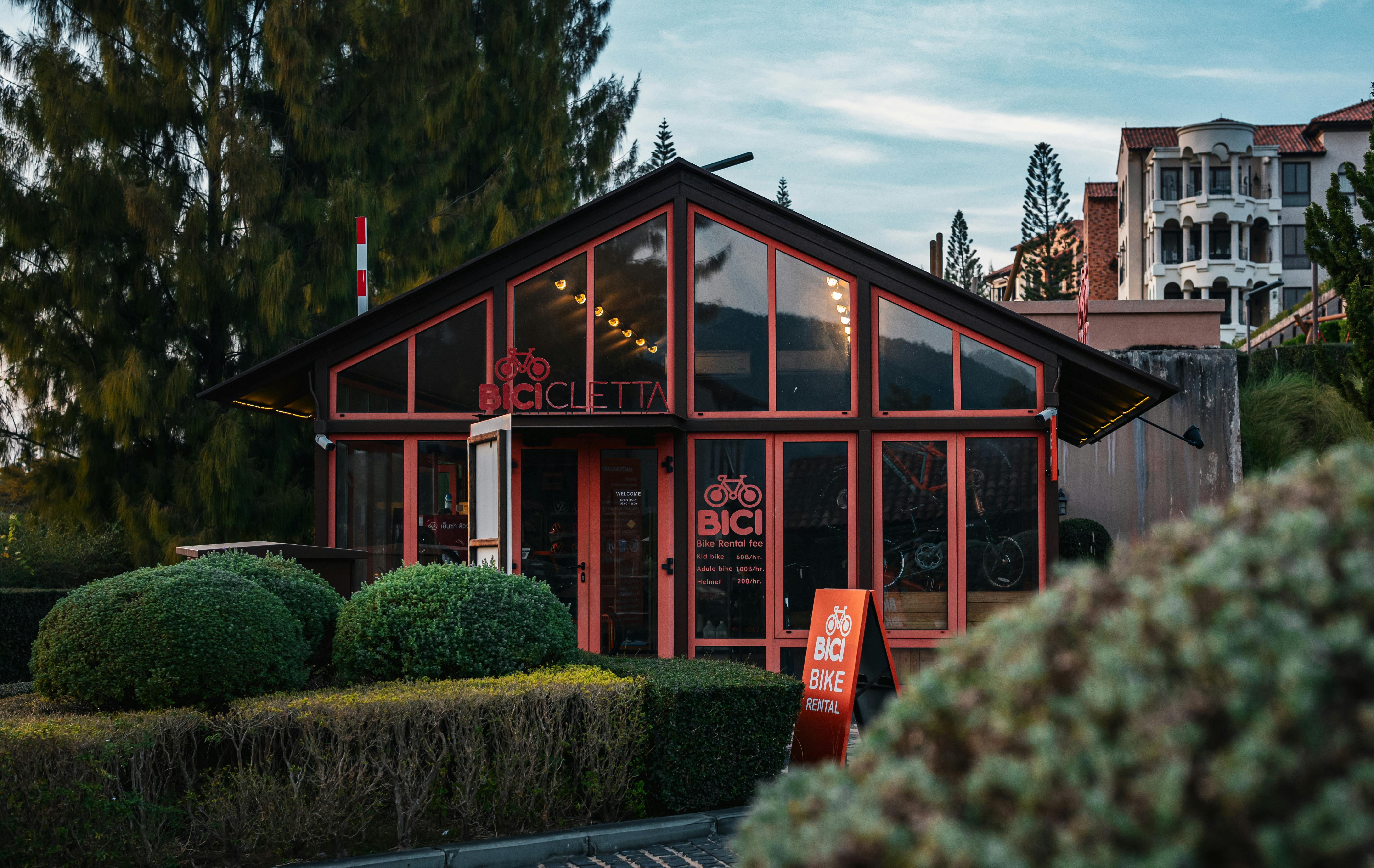 Exterior view of a charming bicycle rental shop surrounded by lush greenery in Thailand.